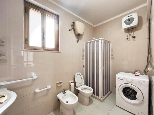 ein Badezimmer mit Toilette, Waschbecken und Waschmaschine in der Unterkunft La Dimora di Helen in Monopoli