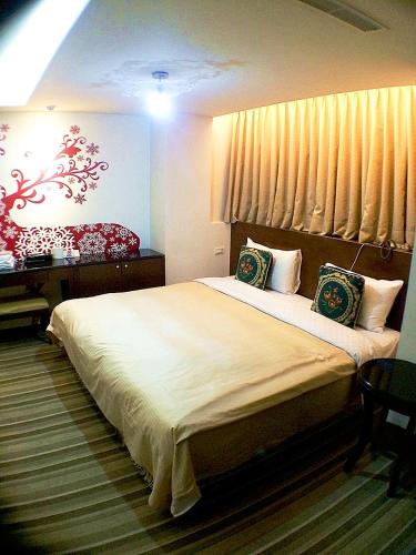 a bedroom with a large bed and a window at Lio Hotel - Taipei Main Station in Taipei