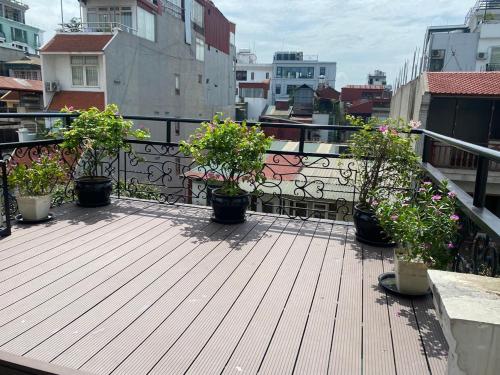 a deck with potted plants on a balcony at Hanoi Diamond King Hotel & Travel in Hanoi
