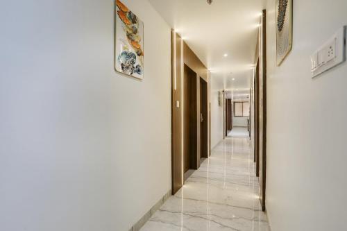 a hallway with white walls and gold doors at FabHotel Prime Panchwati Regency in Bhopal