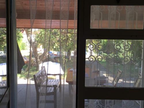 a view of a patio from a window with chairs at Maison de Vacances in Vama Veche