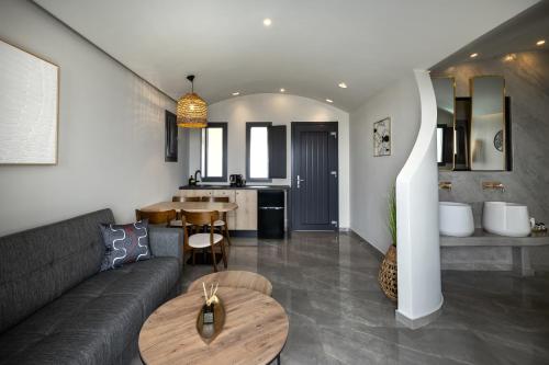 a living room with a couch and a table at Kudos Suites Firostefani in Fira