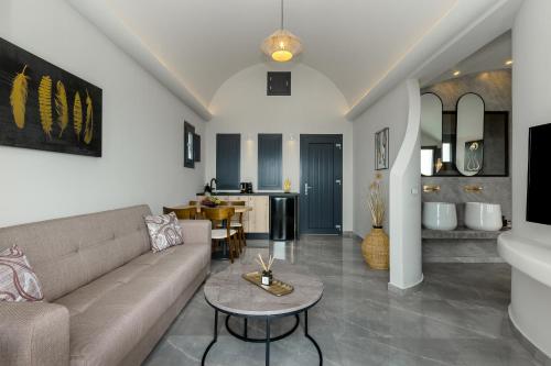 a living room with a couch and a table at Kudos Suites Firostefani in Fira