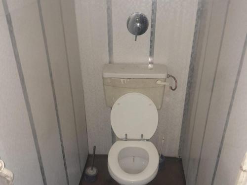a small bathroom with a toilet in a stall at North Lodge Cottages in Durban