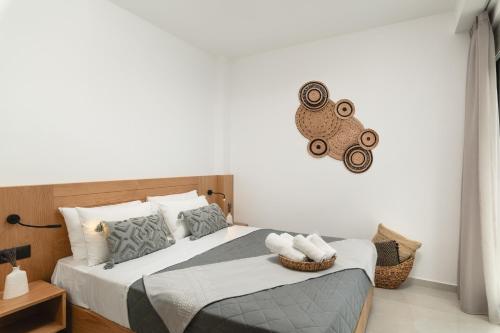 a bedroom with a bed and a clock on the wall at Elia City Apartments in Chania Town