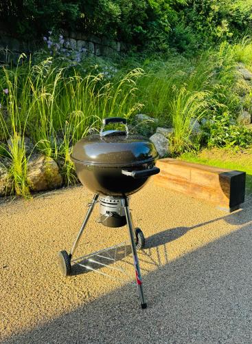 a charcoal grill on a stand in a garden at Stará Škola Mariánská in Albrechtice v Jizerských horách