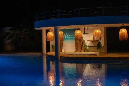 a resort with a swimming pool at night at Ycona Eco-Luxury Resort, Zanzibar in Dikoni