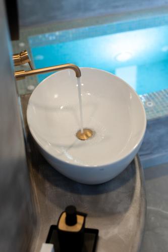 a white bowl sitting on top of a counter at Kudos Suites Firostefani in Fira