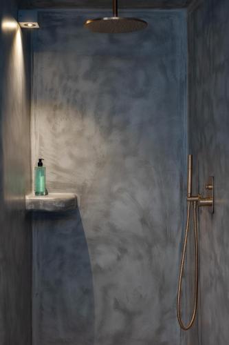 a bathroom with a shower and a sink at Kudos Suites Firostefani in Fira