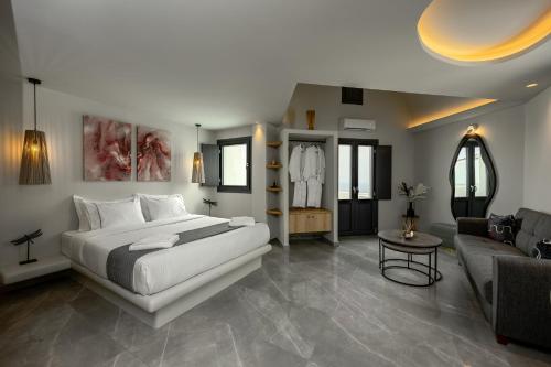 a bedroom with a bed and a living room at Kudos Suites Firostefani in Fira