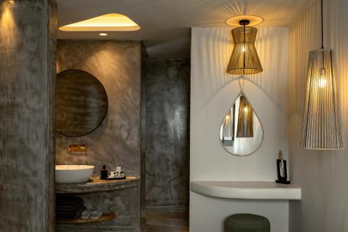 a bathroom with a sink and a mirror at Kudos Suites Firostefani in Fira