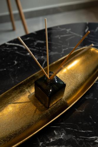 a metal object with sticks in it on a table at Kudos Suites Firostefani in Fira