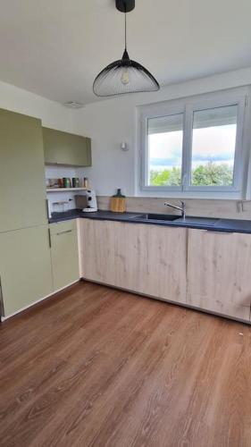 a kitchen with a wooden counter top in a room at Le gîte de la Sienne in Regnéville-sur-Mer