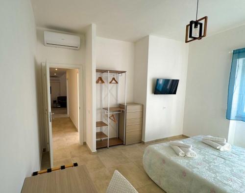 a bedroom with a bed and a table in it at VILLA BELVEDERE Seaview Apartments - Relax a due passi dal mare in Anzio