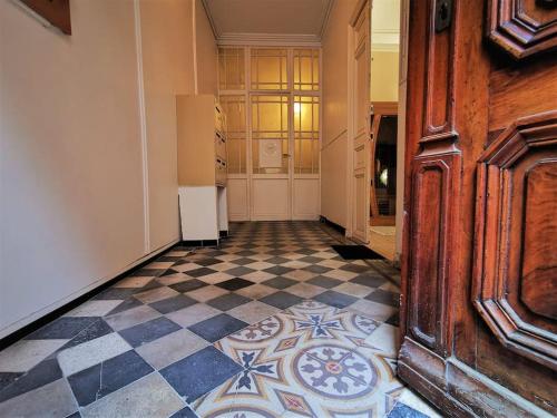 a hallway with a checkerboard floor in a building at Loveroom Venise Provençale in Martigues