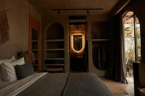 a bedroom with a bed and an open doorway at @before sunset in Cesme