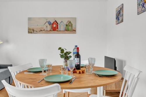 a wooden table with chairs and a bottle of wine at Villa Manuela in Lajares
