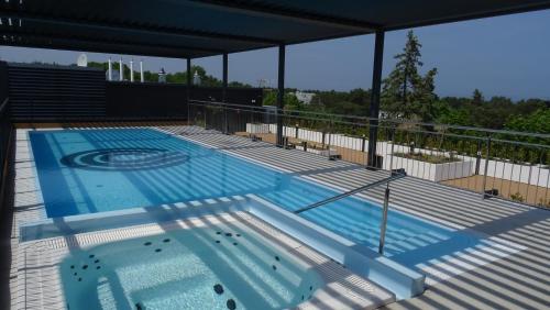a large swimming pool on top of a building at Apartamenty Świnoujście - Seaside Garden 59 in Świnoujście