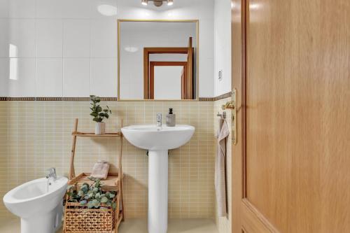 a bathroom with a sink and a toilet and a mirror at Villa Manuela in Lajares