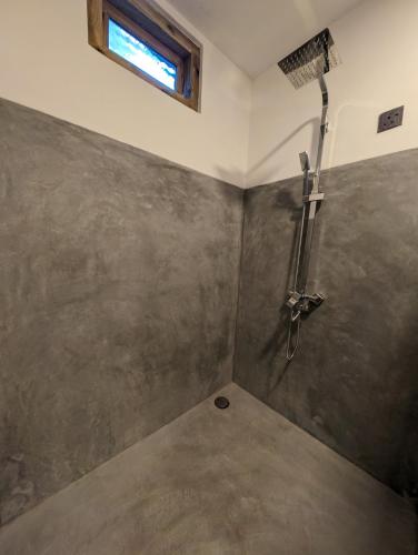 a bathroom with a shower in a room at Beach View in Arugam Bay