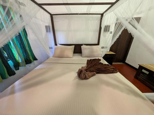 a white bed with a blanket on top of it at Beach View in Arugam Bay