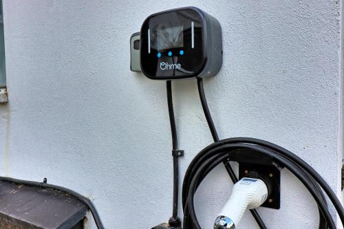 a cord hooked up to a wall with a charger at LMV Property - Modern Luxury Family Home in Theydon Bois With London Skyline Views in Theydon Bois