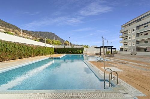 a swimming pool in the middle of a building at Bajamar en armonía in Bajamar