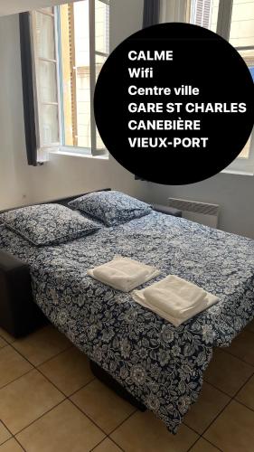 a bed in a room with two pillows on it at Thubaneau St Charles Canebière Vieux port in Marseille