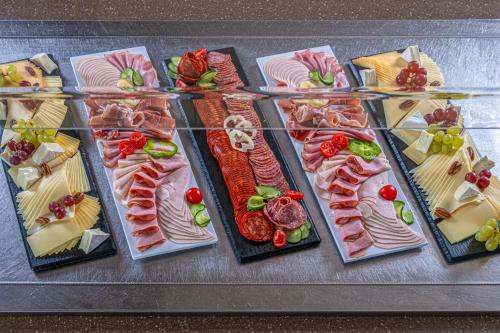 a bunch of different types of food on a table at Lifestyle Hotel Mátra in Mátraháza