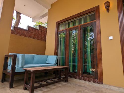 a blue couch sitting in a room with a table at Beach View in Arugam Bay