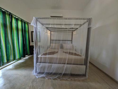 a bed in a plastic container in a room at Beach View in Arugam Bay