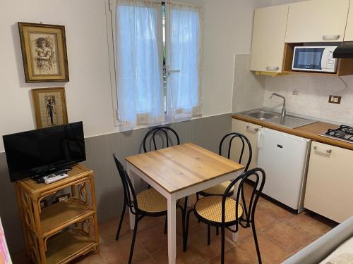 a kitchen with a table and chairs in a kitchen at Camping Roma in Ventimiglia