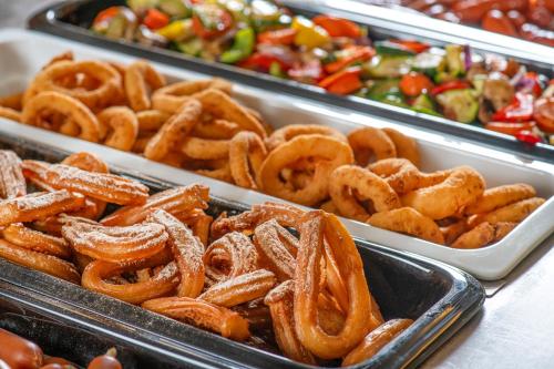 a tray of pretzels and other foods in trays at Lifestyle Hotel Mátra in Mátraháza