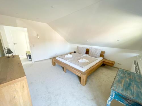 a room with a bed with two pillows on it at Ferienhaus Lindenweg Bad Bederkesa in Bad Bederkesa