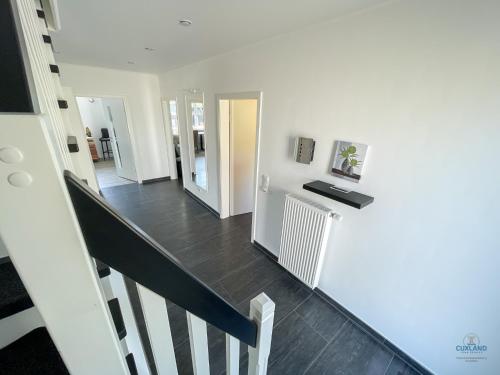 a hallway with a staircase and a stair case at Ferienhaus Lindenweg Bad Bederkesa in Bad Bederkesa