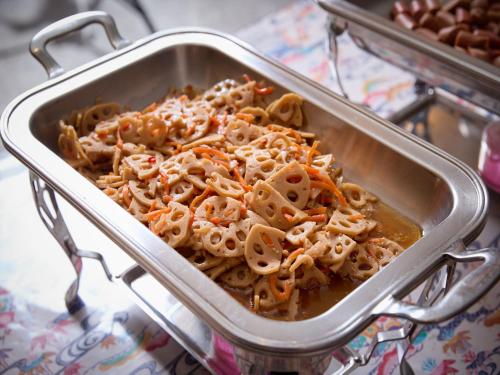 a metal pan filled with pasta on a table at Hotel Miyuki Beach in Onna