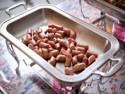 a container of hot dogs in a pan on a table at Hotel Miyuki Beach in Onna
