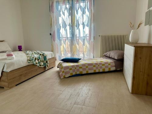 a bedroom with a bed and a window in a room at Attico al Sovrano - Nel cuore della Puglia! in Turi