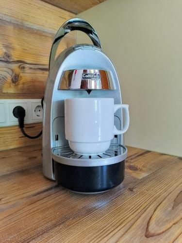 a coffee maker is sitting on a wooden floor at Appartements Kolberhof in Alpbach
