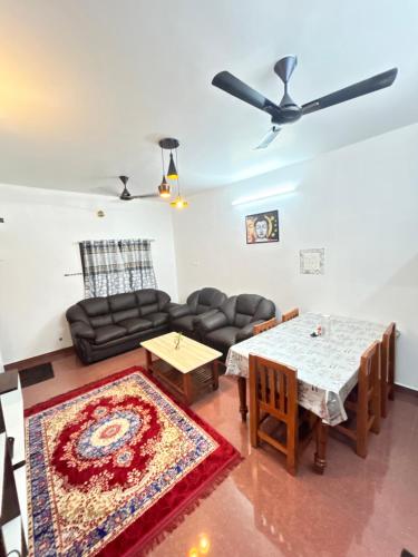 a living room with a couch and a table at Cardiff palace in Puducherry