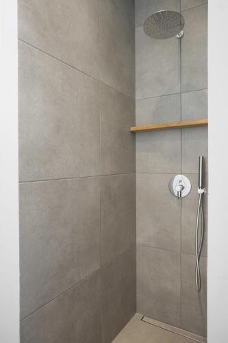 a shower with a glass door with a shower head at Villa Gianna Maria in Paleros