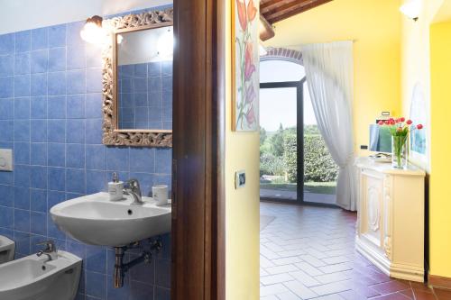 a bathroom with a sink and a mirror at Country House Oasi Verde Near Florence in Cerreto Guidi
