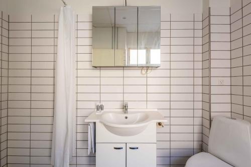 a bathroom with a sink and a toilet and a mirror at Perfect City-Break Apartment in CPH in Copenhagen