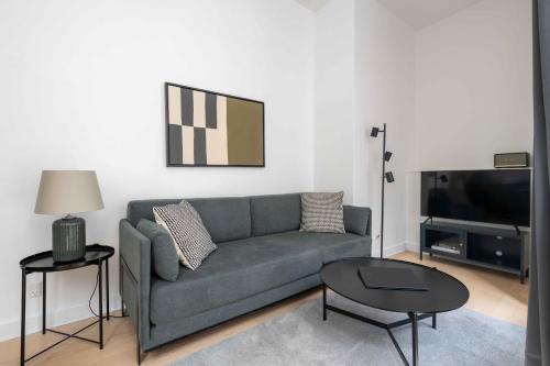 a living room with a couch and a tv at Perfect City-Break Apartment in CPH in Copenhagen