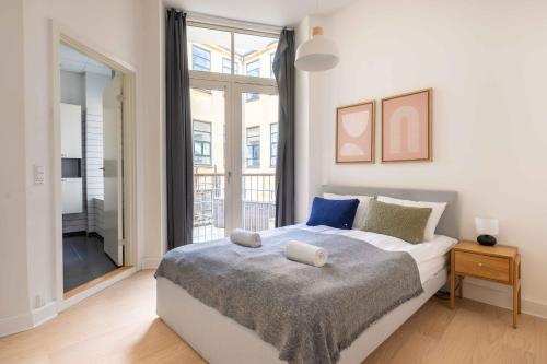 a bedroom with a bed and a large window at Perfect City-Break Apartment in CPH in Copenhagen