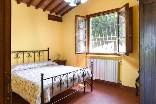 a bedroom with a bed and a window at Country House Oasi Verde Near Florence in Cerreto Guidi