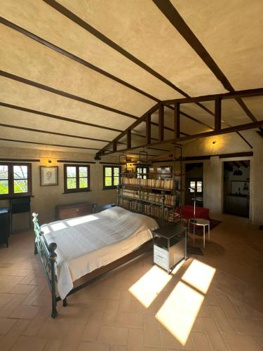 a large bedroom with a large bed in a room at La Tana del Grifo - Podere Amodeo in Chiusi