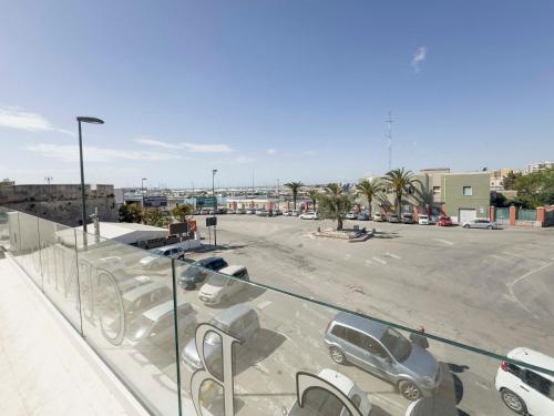 a parking lot with a lot of parked cars at Centro Storico Rooms & Suites in Manfredonia