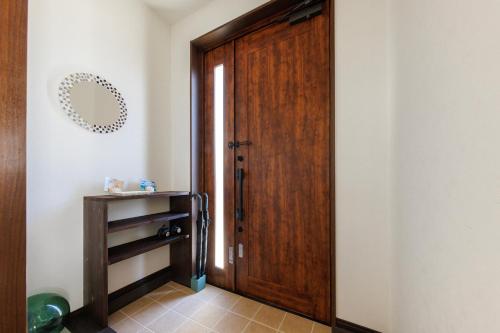 a hallway with a wooden door and a shelf at Kerama the day in Awaren