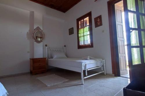 a white bench in a room with a window at Xrysanthi's dream house in Zagora